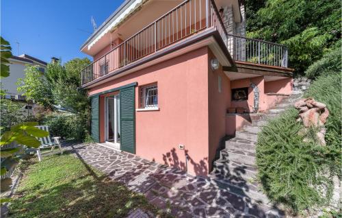 a house with a staircase leading up to a balcony at Villa Liselote in Gargnano
