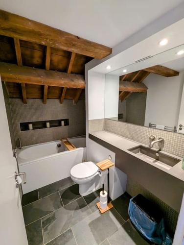 a bathroom with a toilet and a sink and a tub at Ocean City Royal Retreat in Plymouth