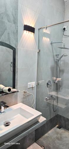 a bathroom with a sink and a shower at Wis Villa in Galle
