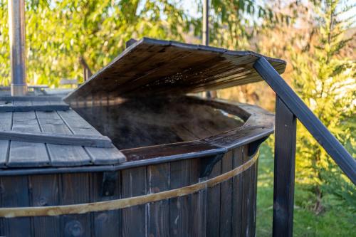 a wooden tub with a roof on top of it at Glamp In Style Pods Resort in Bran