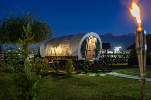 a small tent sitting in a yard at night at Glamp In Style Pods Resort in Bran
