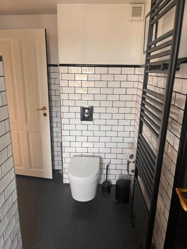 a bathroom with a white toilet in a room at Townhouse in Odense