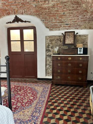 a room with a door and a dresser and a rug at ZuccarelloDreams in Zuccarrello
