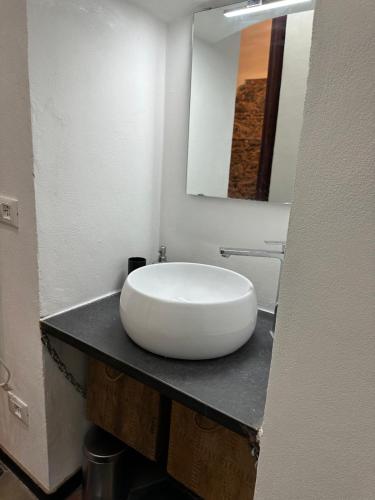 a bathroom with a large white sink on a counter at ZuccarelloDreams in Zuccarrello