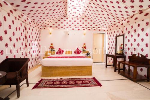 a bedroom with a bed in a pink room at Desert Dream Royal Camp & Pool in Jaisalmer