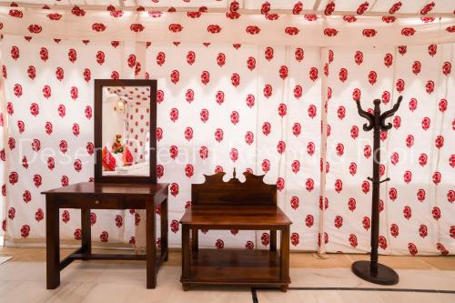 a room with two tables and a mirror at Desert Dream Royal Camp & Pool in Jaisalmer