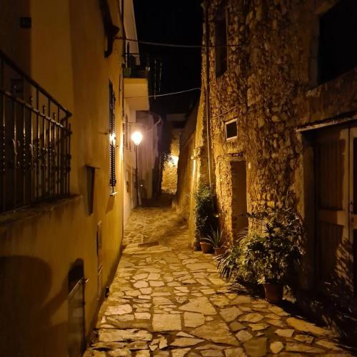 an empty alley at night with a street light at ZuccarelloDreams in Zuccarrello
