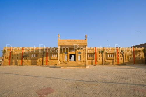 an old building with a sign on the side of it at Desert Dream Royal Camp & Pool in Jaisalmer
