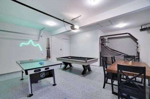 a room with a ping pong table and a ping pong ball at Cozy Poconos Retreat Hot tub, Game room and igloo in Tobyhanna