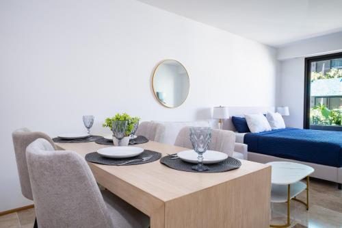 a living room with a dining table and a couch at Menesse Town Tower 202 condo in Playa del Carmen