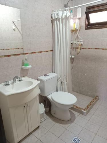 a bathroom with a toilet and a sink at Uco Slow in Tunuyán