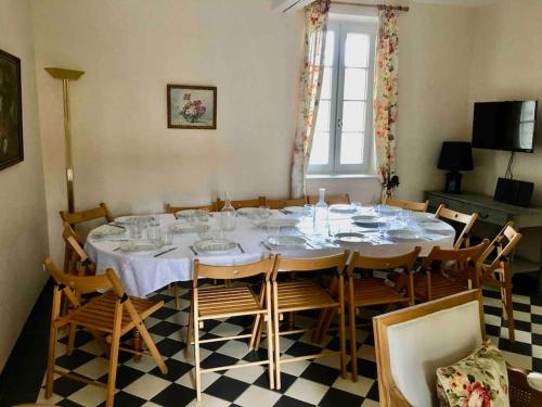 a dining room with a large table and chairs at La Maison des Champs in Cintegabelle