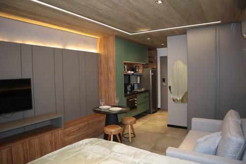 a bedroom with a bed and a living room at ED NEW TIME 1121 Studio de Luxo à BEIRA MAR de Maceió in Maceió