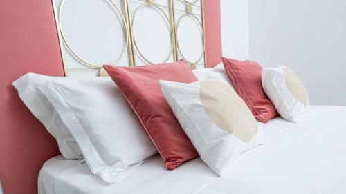a pile of pillows sitting on top of a bed at Nice & Love in Noto