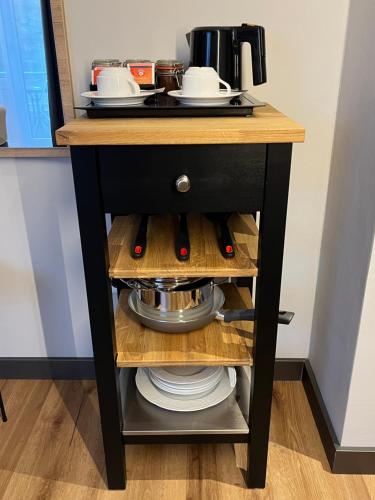 a small black table with some dishes on it at Hotel Senator in Bielefeld