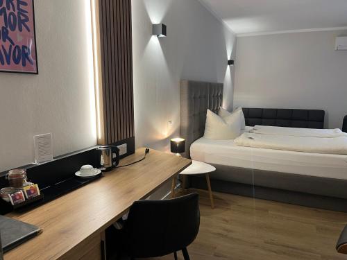 a hotel room with a bed and a desk with a desk at Hotel Senator in Bielefeld