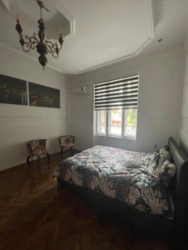 a bedroom with a bed and a window at Apartman Car new on booking in Odžaci