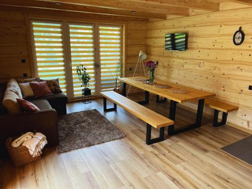 a living room with a table and a couch at Pod Skałką in Nienadowa