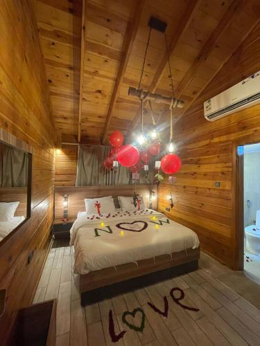 a bedroom with a bed in a room with wooden walls at اكواخ السمو الريفيه in Khalij Salman