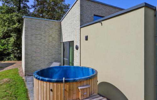 a large blue tub sitting next to a building at Cozy Home In Lembruchdümmer See in Lembruch
