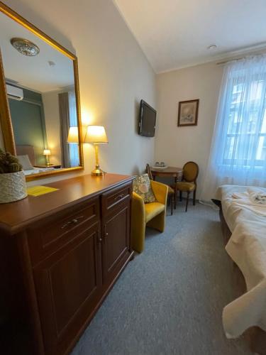 a hotel room with a mirror and a bed at Apple Economy Hotel in Kaunas