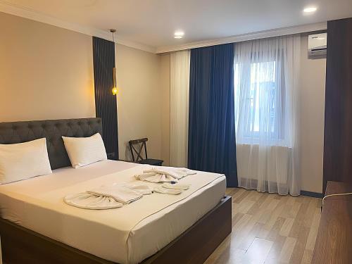 a bedroom with a bed with towels on it at La Vie Suite Hotel in Istanbul
