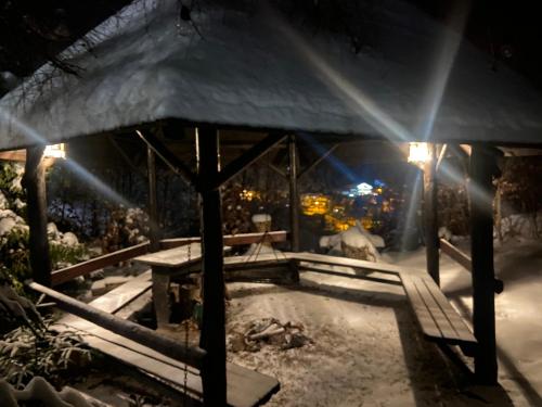 a gazebo in the snow at night at Apartament Widoknastok in Korbielów