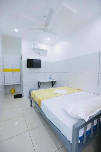 a hospital room with a bed and a table at SR Residency in Kollam