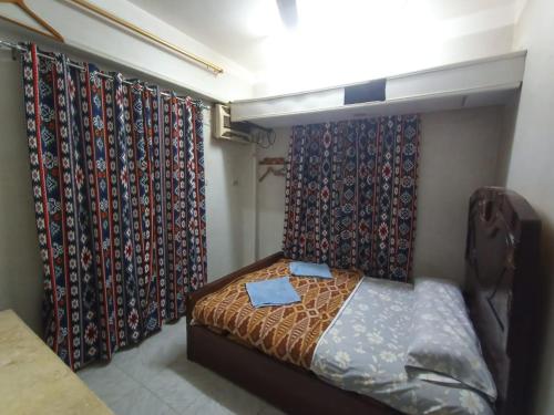 a bedroom with curtains and a bed in a room at david hostel in Aswan