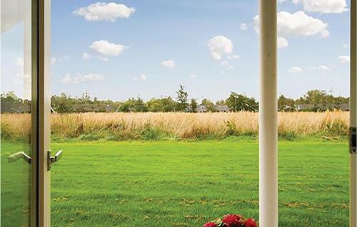 a view of a field from a door with a window at Holiday Home Blommestien V Denmk in Marielyst