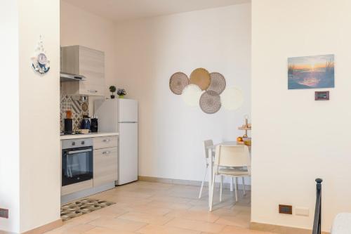 a kitchen with a refrigerator and a table with chairs at Vista mare AirPort in Fiumicino