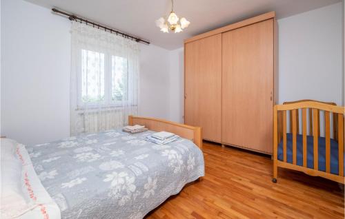 a bedroom with a bed and a crib and a window at Six-Bedroom Holiday Home In Barban in Barban
