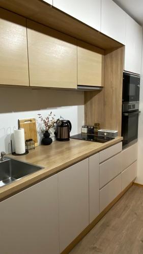 a kitchen with white cabinets and a counter top at Narva Apartments N1 in Narva