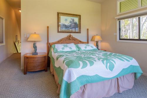 a bedroom with a large bed and two lamps at 2511 Ridge in Kahana