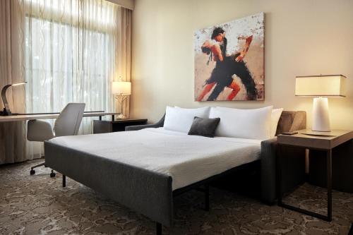 a hotel room with a bed and a painting on the wall at Andell Inn in Kiawah Island