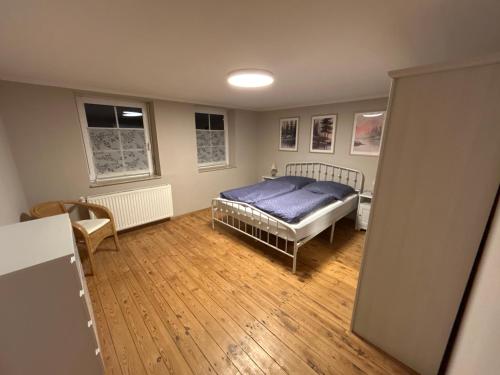 a bedroom with a bed and a wooden floor at Ferienwohnung Elbetraum in Tangermünde