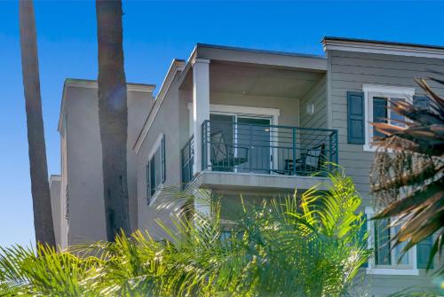 a house with a balcony and palm trees at Marina Del Mar 315B in Oceanside