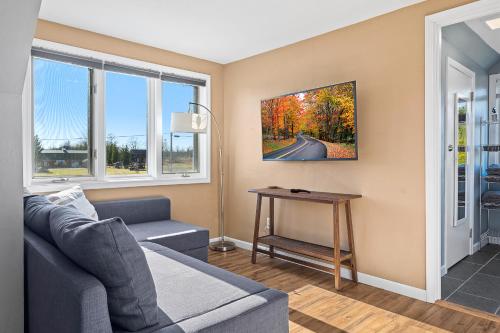 a living room with a couch and a table at Bird's Nest - Above Bakery Cozy Studio, Perfect for Couples! in Sister Bay