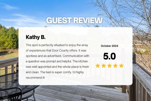 a sign that says guest review on a deck at Bird's Nest - Above Bakery Cozy Studio, Perfect for Couples! in Sister Bay