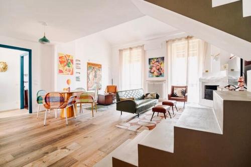 a living room with a couch and a table at 149 BORGO TICINO SUITE Attico di Lusso con Terrazzo e Parking Privato in Pavia