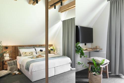 a bedroom with a canopy bed and a tv at The Sopa - heritage premium houses in Zakopane