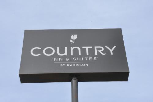a sign for a country inn and suites at Country Inn & Suites By Radisson Bloomington-Normal West, IL in Bloomington