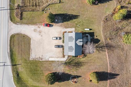 an aerial view of a yard with a house and cars at Bird's Nest - Above Bakery Cozy Studio, Perfect for Couples! in Sister Bay