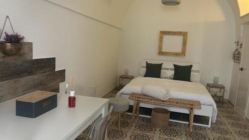 a bedroom with a bed and a table in it at Vicolo 4 Locazione Turistica in Monopoli