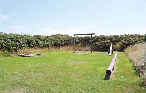 a park with a bench in the grass at Holiday Home Ringkøbing 48 in Søndervig