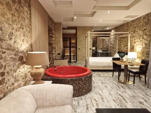 a living room with a tub in the middle of a bedroom at EL PALACETE SOÑADO o in La Roza