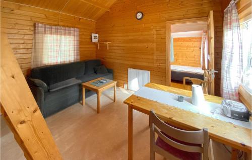a living room with a couch and a table at Stuga 3 in Nybro