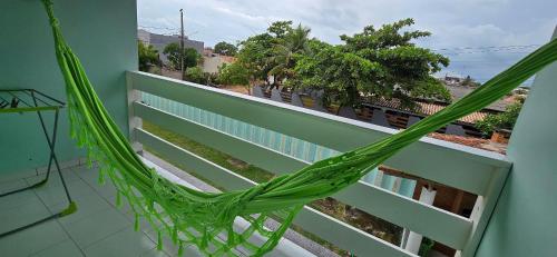 a hammock on a balcony of a building at Vila Mar Flats - 1 Dorm - Guriri - 800m da Praia in Guriri
