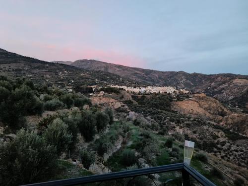 a view of a valley with trees and mountains at Casa Rural Chalet Venta del Aire Cortijo Terron in Lanjarón