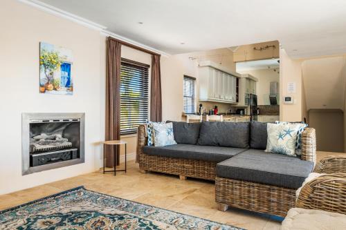 a living room with a couch and a fireplace at Chandler Heights in Knysna